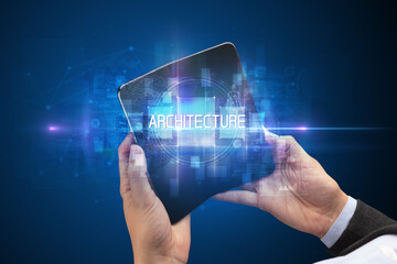 Businessman holding a foldable smartphone with ARCHITECTURE inscription, new technology concept