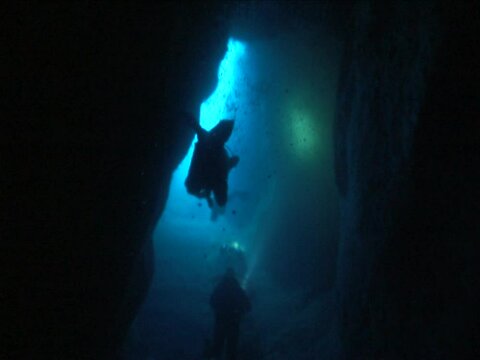 cave diving underwater scuba divers exploring caves and having fun ocean scenery 