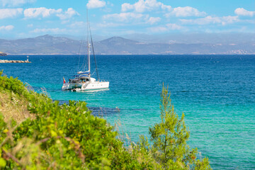 Sail boat, yacht in a beautiful bay with blue water during sunny day, Chalkidiki, Greece