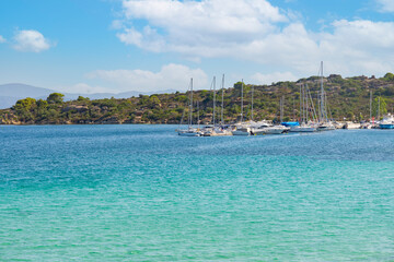 Sail boat, yacht in a beautiful bay with blue water during sunny day, Chalkidiki, Greece