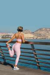 beautiful latin woman does fitness outdoors near the beach