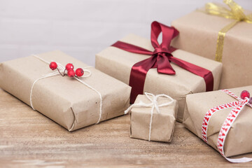 Christmas gift boxes and glowing garland on wooden background. New Year presents.