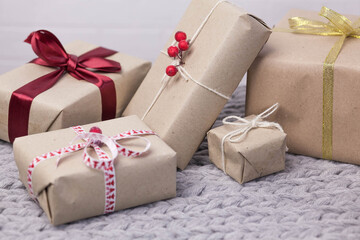 Christmas gift boxes on knitted background. New Year presents.