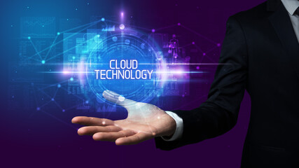 Man hand holding CLOUD TECHNOLOGY inscription, technology concept