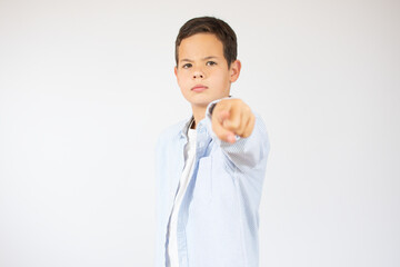 Portrait of happy boy showing thumbs up gesture, isolated white background