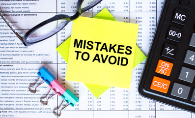 Text Mistakes To Avoid on yellow stickers with calculator, eyeglasses and paper clips