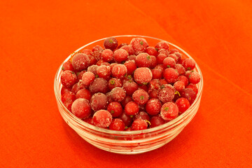 frozen currant berries lie in a vase