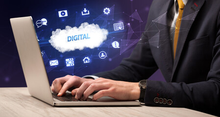 Businessman working on laptop with DIGITAL inscription, modern technology concept