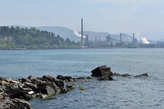 A Shot Of The Clear Water On The Background Of The Sea Port Factory Causing Environmental Pollution