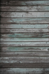 Obraz premium fragment of a fence made of old wooden boards with remnants of paint and nails, natural texture, background