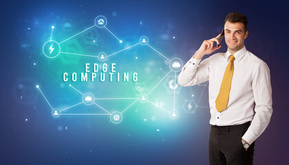 Businessman in front of cloud service icons with EDGE COMPUTING inscription, modern technology concept