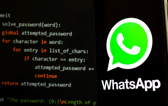 Stone / UK - October 29, 2019: WhatsApp Logo On The Smartphone In A Dark Room And Piece Of Python Code For Brute Force At The Blurred Background. Illustrative For WhatsApp Hack News.