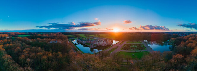 Ancient castle on the water, beautiful sunset, sun, clouds, landscape, autumn.