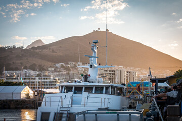 waterfront in cape town during sunset with signal hill in background