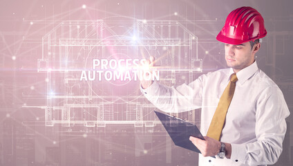 Handsome architect with helmet drawing PROCESS AUTOMATION inscription, new technology concept