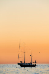 sailboat at sunset at Corona del Mar beach in Orange County California