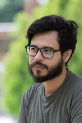 portrait of a mexican man with beard and glasses 