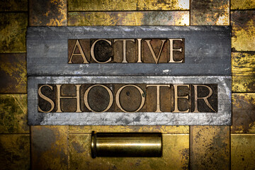 Active Shooter text with copper gun casing on grunge textured authentic copper and gold background