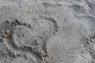 Character heart painted on the sand of Valentine's Day prazdink on open-piece copyspace