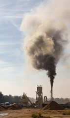 Fototapeta na wymiar Cement chimney generating harmful emissions and pollution to the environment