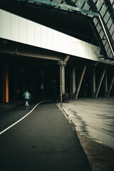 Woman driving a bicycle into a tunnel