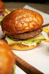 Set of burgers with french fries and ketchup sauce.