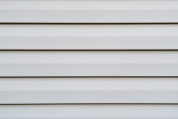 Straight on view of old vinyl siding for house