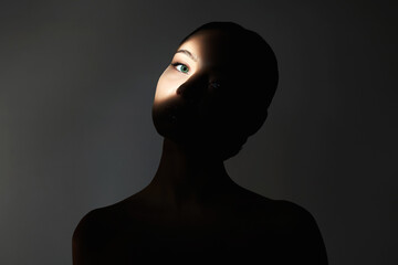 young woman with shadow ob the face