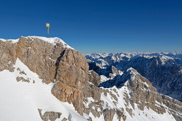 Golden summit cross at Zugspitze, Bavaria, Germany, wintertime