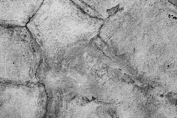 Texture of a concrete wall with cracks and scratches which can be used as a background