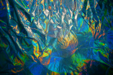 Iridescent fabric trendy cloth holographic background. Chromatic decomposition of color