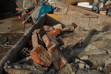 Bricks and rubbish after demolition with rotten and rusty metals.