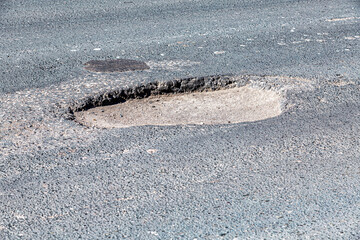 Large pothole an example of poor road maintenance