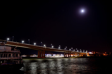Fototapeta na wymiar night. road bridge over the river with lights. 
