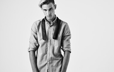 A faded photograph of a man in a shirt on an isolated background and a tie in his hands