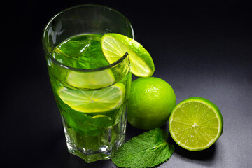 Tradition Summer drink mojito with lime and mint, dark background, close-up