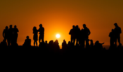 Fototapeta na wymiar Silhouette of people looking at sunset in Algarve Portugal