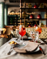 Served restaurant table with aperitif cocktails and mediterranean appetizers 