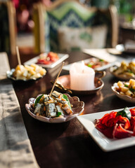 Side view on table served with different gourmet appetizers