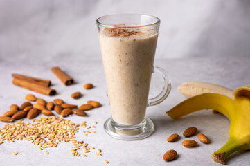 Healthy fresh vegan oat smoothie with almond nuts and bananas. Morning breakfast. Selective focus. 