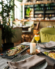 Side view on restaurant table served with European fusion cuisine appetizers