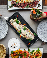 Top view on restaurant table served with European fusion cuisine appetizers