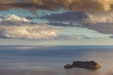 Dramatic sky in golden hour with silhouette of the famous Vila Franca islet, São Miguel - Azores PORTUGAL