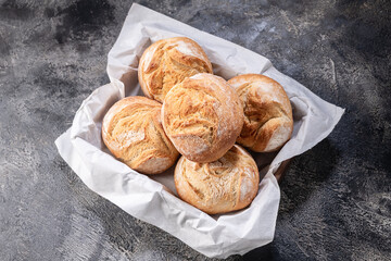buns in a basket on a wooden table