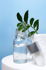 Transparent Glass Bottle with Pipette cosmetic Serum on Stage Podium. Blue Background