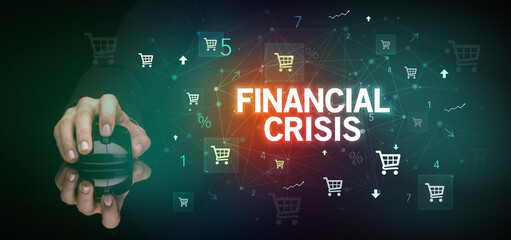 hand holding wireless peripheral with FINANCIAL CRISIS inscription, online shopping concept