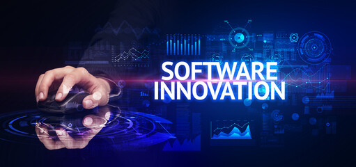 hand holding wireless peripheral with SOFTWARE INNOVATION inscription, modern technology concept