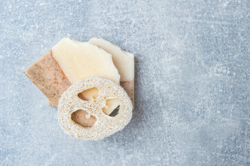 Obraz na płótnie Canvas Handmade soap and loofah sponges on grey background. Eco lifestyle concept...