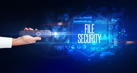 hand holding wireless peripheral with FILE SECURITY inscription, cyber security concept