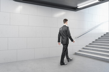 Fototapeta premium Businessman walking in contemporary metro station